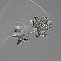Сережки-пусети Метелики, білі стрази, метал під срібло, 1,5 см купити біжутерію дешево оптом в інтернеті