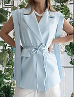 Жіночий жилет подовженого силуету під пояс, на підкладці, з повноцінними кишенями