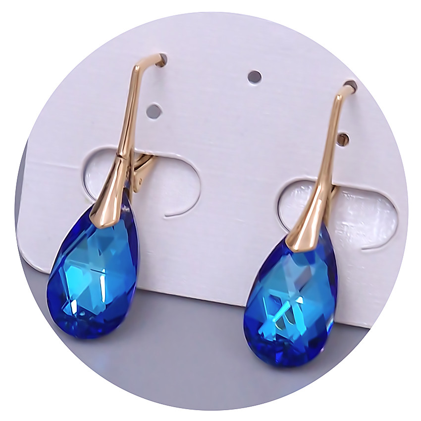 Сережки XР. Позолота 18К. Камені: Swarovski синього кольору. Довжина: 30 мм. Ширина: 9 мм.