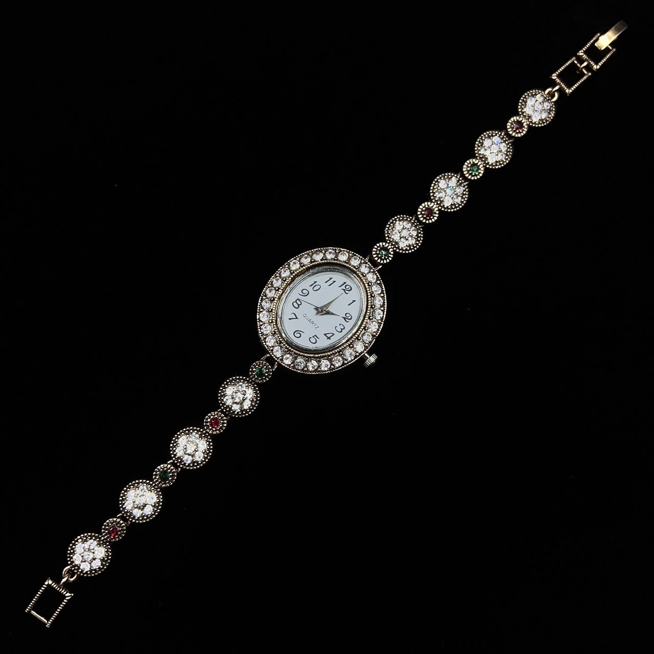 Женские часы винтажные овальные кварцевые в золотистом цвете с разноцветными камушками длина 19 см - фото 1 - id-p2633662276