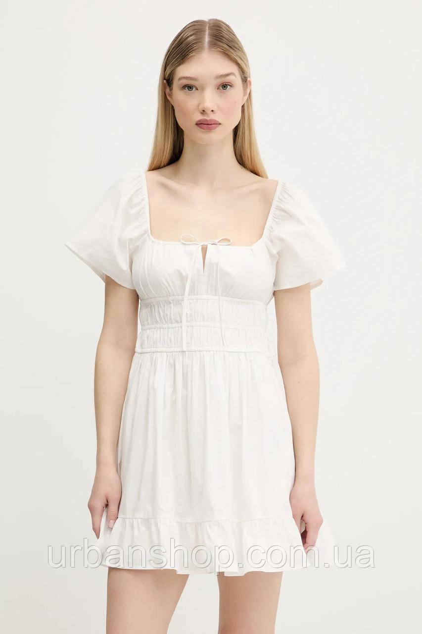 Urbanshop com ua Бавовняна сукня Tommy Jeans колір білий mini розкльошена DW0DW20882 РОЗМІРИ ЗАПИТУЙТЕ