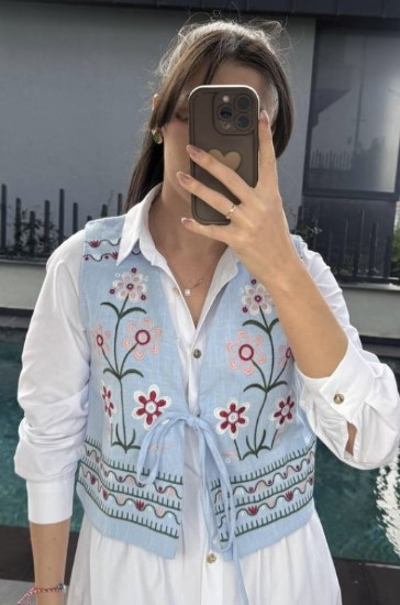 Вишита жилетка блакитного кольору на зав'язках із квітковою вишивкою розміри S, M, L.