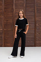 Модний чорний топ із білою аканточкою на рукавах і горловині на дівчинку в розмірі 158 і 164