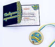 Медаль першокласника з синьою голографією та рельєфним орнаментом  з посвідченням першокласника