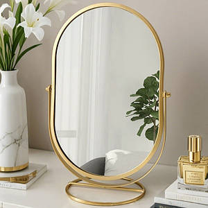 Дзеркало настільної овальної форми металеве на підставці золотистого кольору висота 31 см ширина 20 см