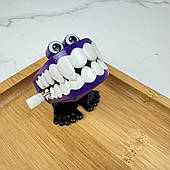 Іграшка у вигляді ходячих зубів з механізмом (фіолетова з іклами), 1 шт