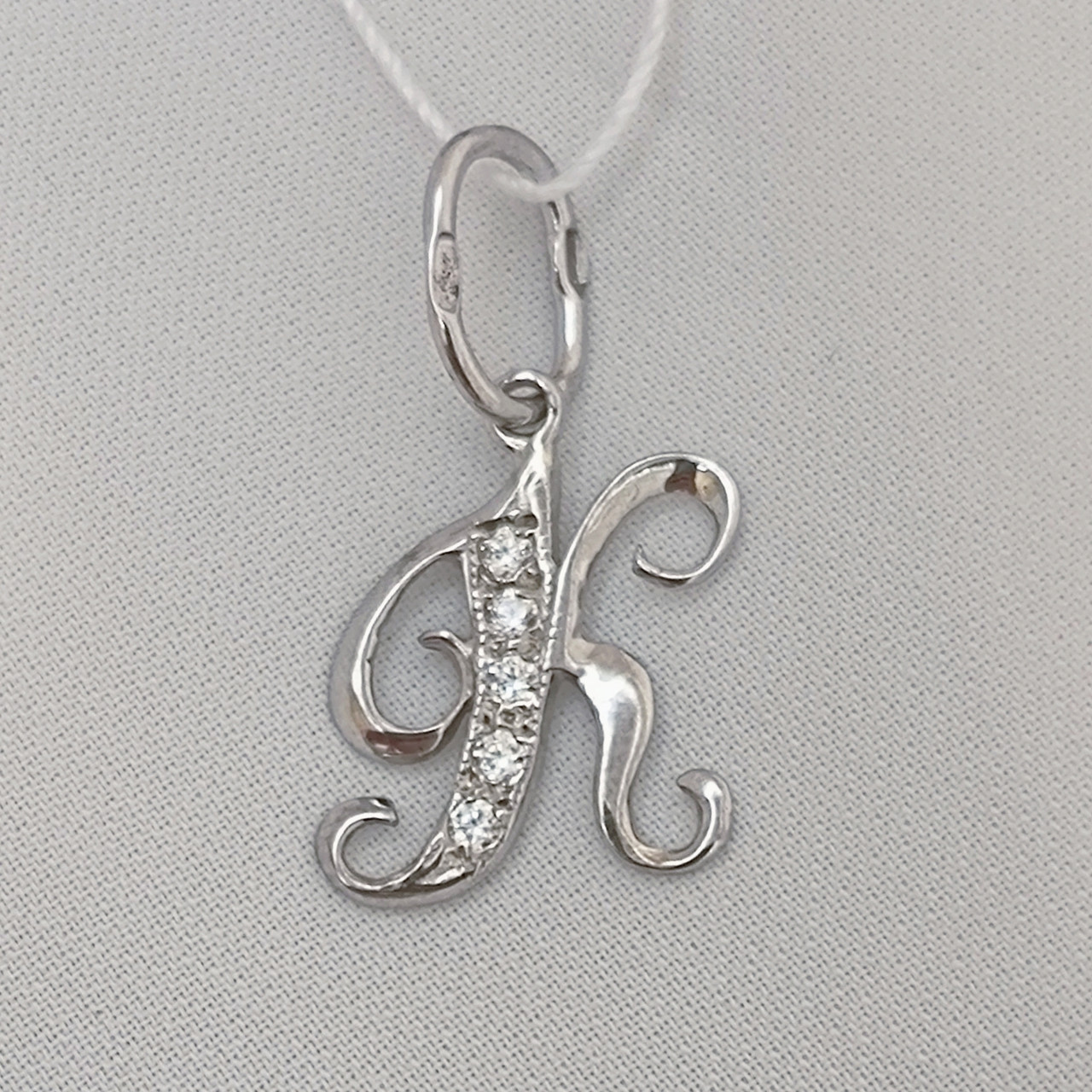 Срібна буква К