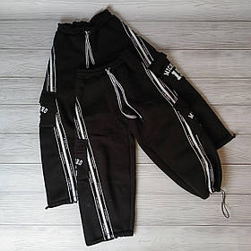 Чорні дитячі теплі спортивні штани з кишенями та регулюванням внизу