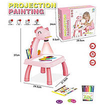 Столик з проєктором YM 2021-7 A (36/2) “Динозаврик” 3 диски, фломастери, серветка, на батарейках, музика, підсвітка, в коробці