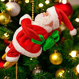 Іграшка новорічна Санта клаус для інтер'єру на мотузці піднімається вгору музикальна на ялинку та балкон, фото 2