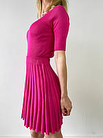 Жіночий трикотажний костюм із топом та спідницею плісе