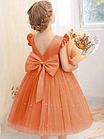 Дитяча святкова сукня для дівчинки помаранчевого кольору з фатиновою спідницею, рюшами та знімним бантом 120 (5-6 років)