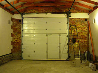 Секционные ворота Алютех промышленной серии с торсионными пружинами для больших гаражей и проемов. Встроенная калитка. Используется стандартный тип монтажа. Рекомендуется управление цепным редуктором или автоматическое.