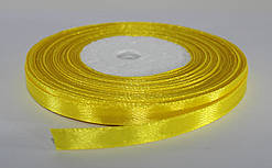 Стрічка атласна. Колір жовтий. Ширина — 0,6 см, довжина — 23 м