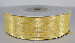 Стрічка атласна. Колір блідо-жовтий. Ширина — 0,3 см, довжина — 123 м
