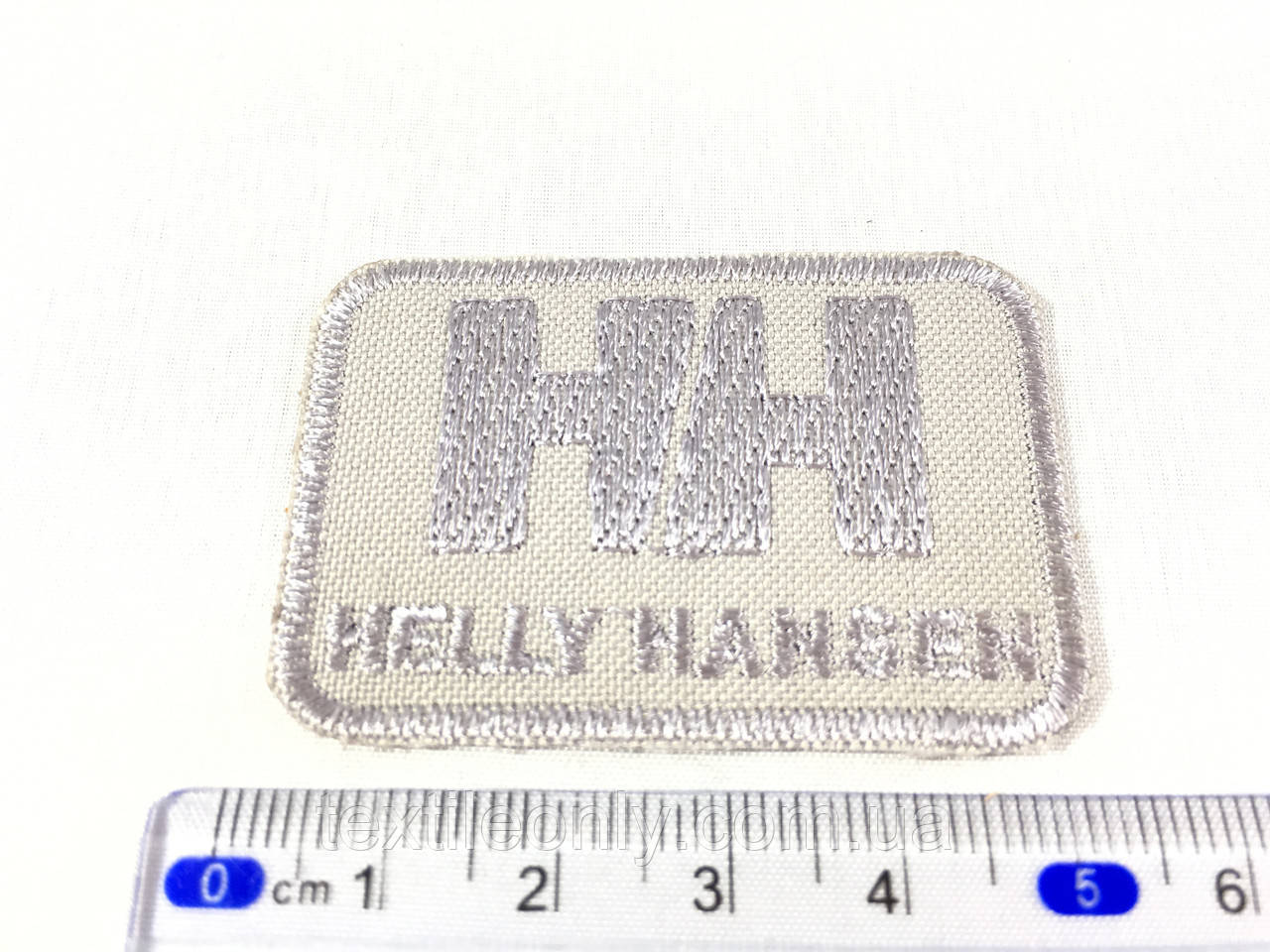 Нашивка HELLY HANSEN колір світло-сірий 50x35 мм