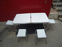 Складаний стіл туристичний і чотири стільчики з тканинними сидіннями.