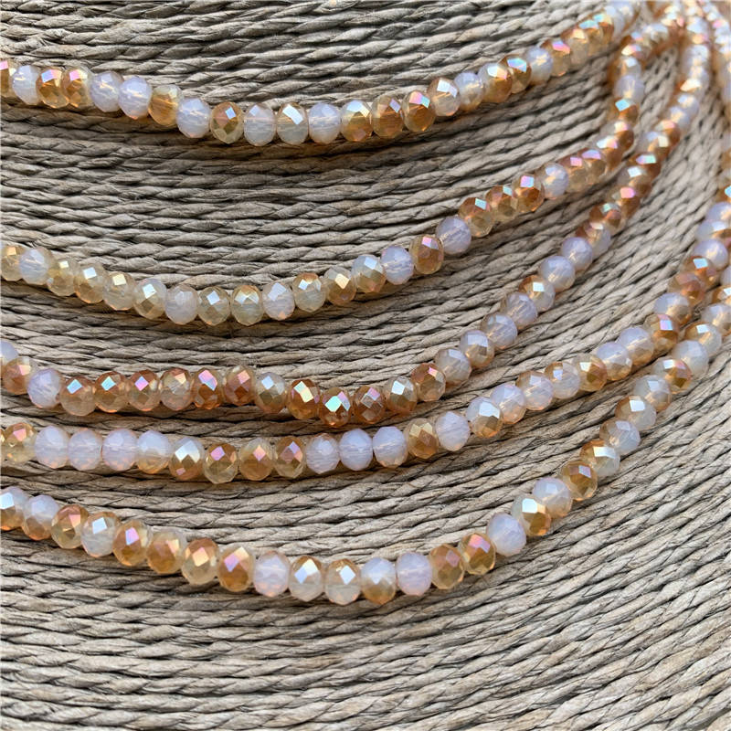 

Бусины хрустальные (Рондель) 4*3 мм пачка 135-140 шт, цвет - шампань с переливом