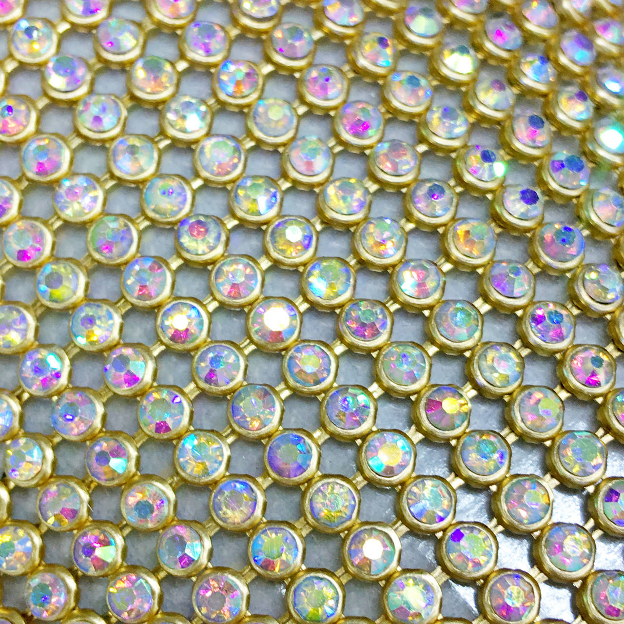 

Стразовая термоткань Металл-золото Стразы Crystal АВ (хамелеоны).Отрезок 1*45см