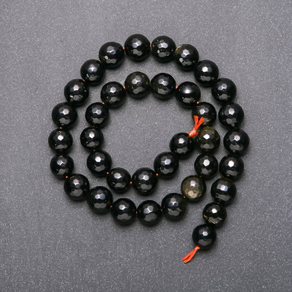 

Бусины на нитке Солнечный Обсидиан граненный шарик d -10(+-)мм L - 37см