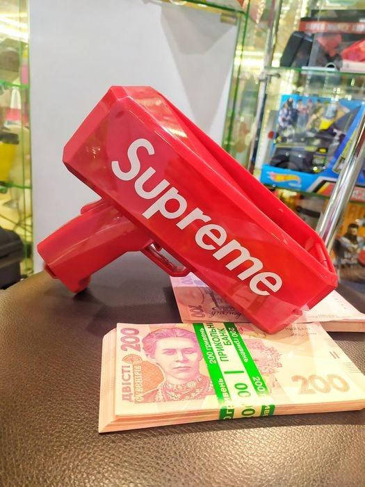 

Пистолет для метания денег Supreme