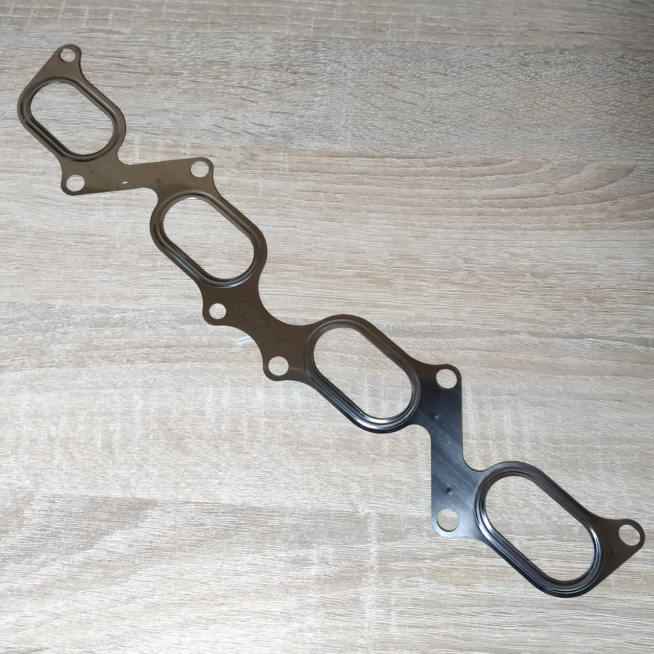 

Прокладка коллектора выпуск Газель,Волга Соболь Рута Бизнес ЗМЗ 409,406,405Euro-3 метал 2 слоя (пр-во ЕзАТИ)