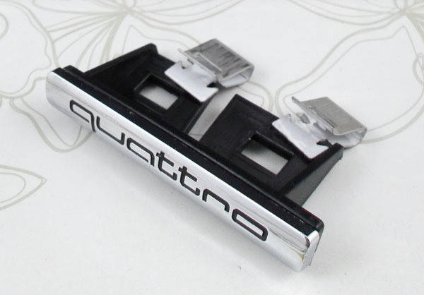 

Эмблема решетки Audi Quattro