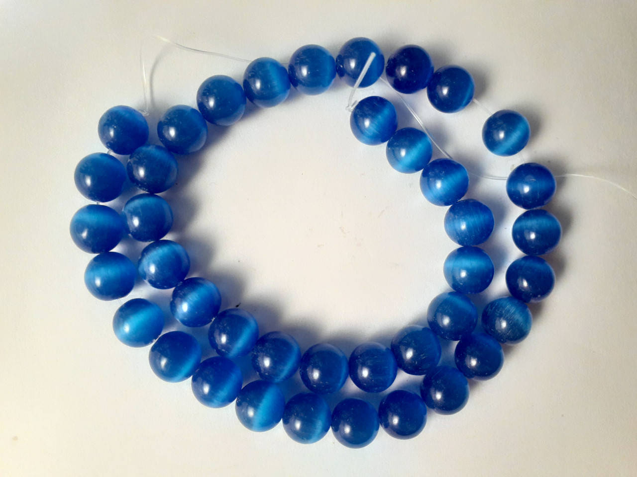 

Бусины на нитке Кошачий глаз d-10vмм L-38см