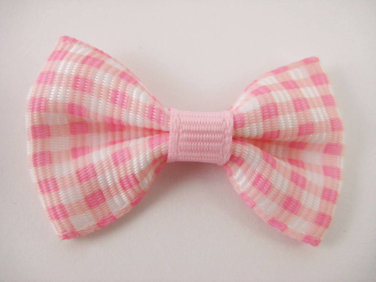 

Бантики. Цвет розовый в клеточку. 4х2 см