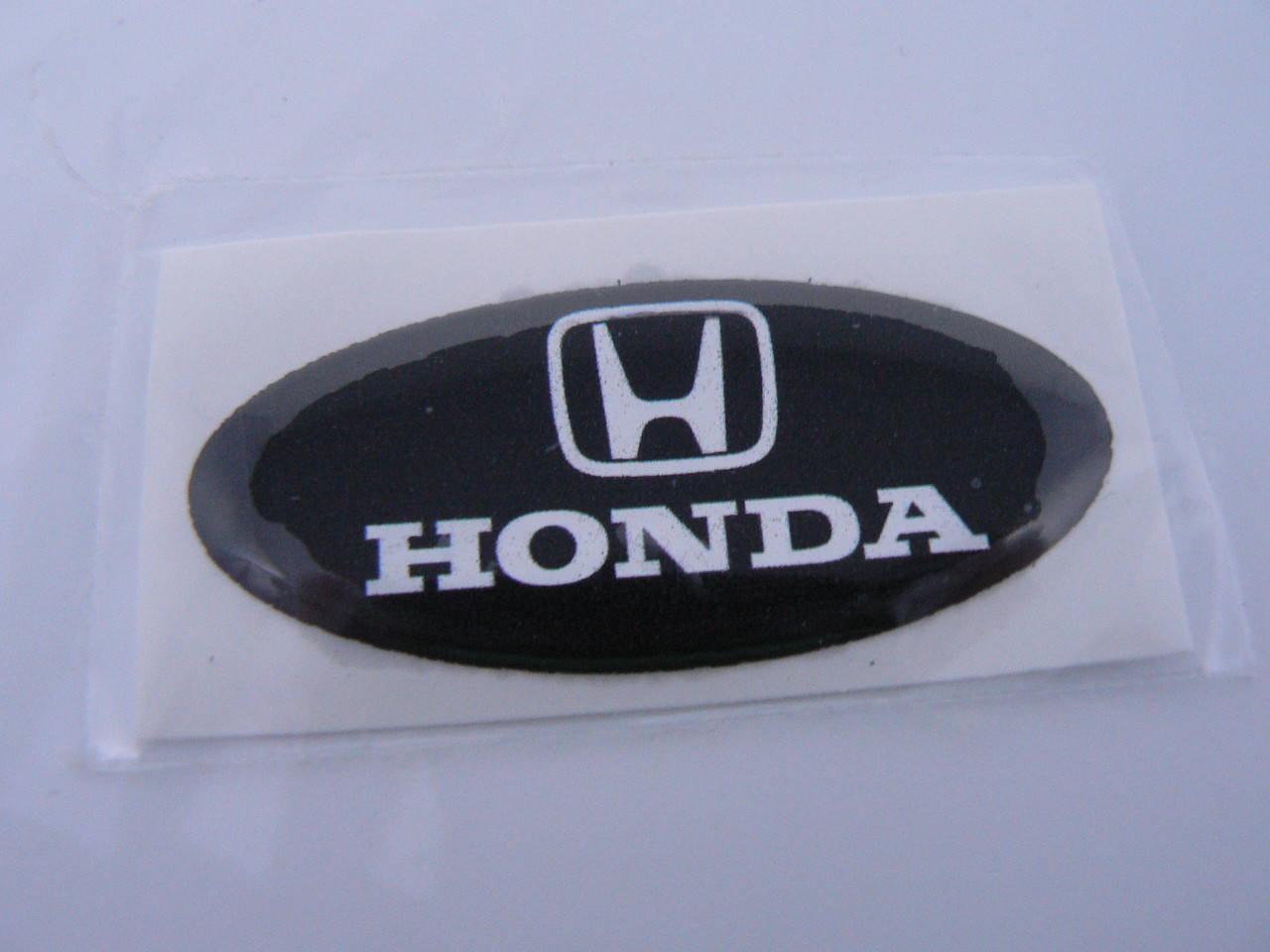 

Наклейка s надпись овал Honda 45х20х1.2мм силиконовая эмблема логотип марка бренд на авто Хонда, Черный