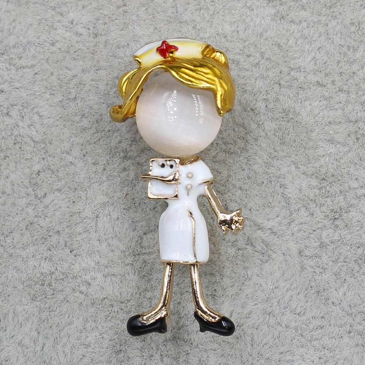 

Брошь металлическая золотистая Доктор покрыта цветной эмалью размер изделия 30х10 мм