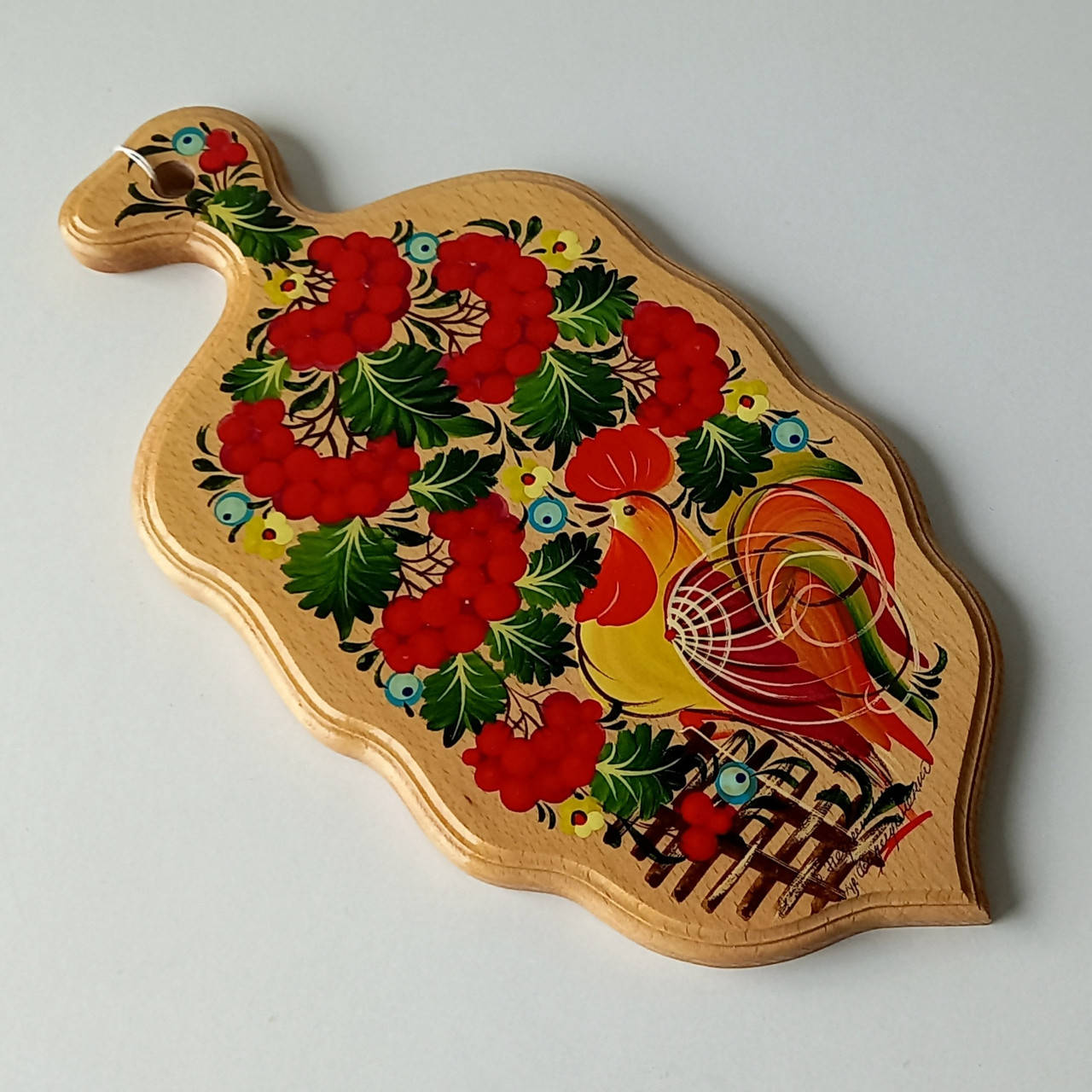 

Дошка кухонна , вжитково-декоративна , листок , петриківський розпис , 17×34,5×1,5 см.