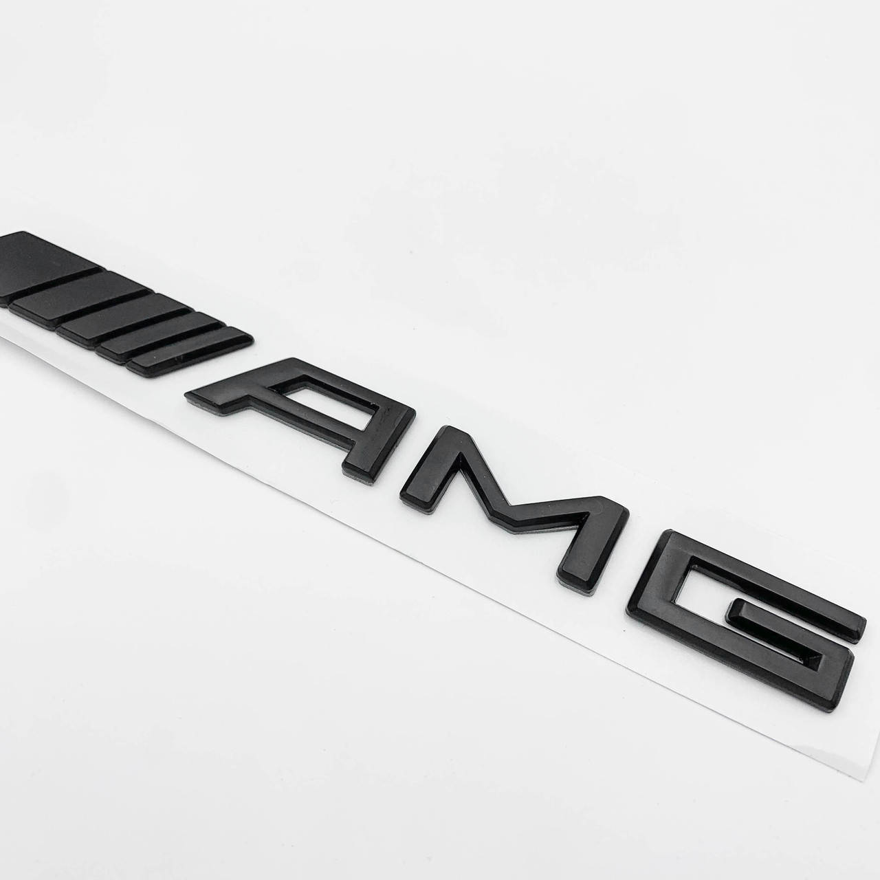 

Эмблема шильдик AMG Mercedes-Benz (Мерседес) 180х15 мм на крышку багажника Черная